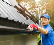 man repairing seamless gutters on house in the fort myers florida area